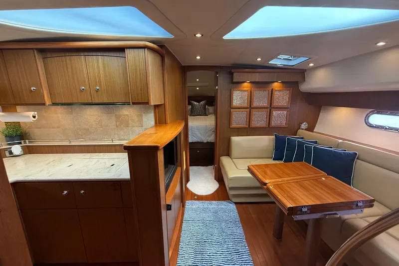  Yacht Photos Pics Luxurious interior of 2014 Tiara Yachts 4500 Sovran with elegant wood finishes and cozy seating.