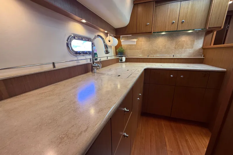  Yacht Photos Pics Luxurious kitchen interior of 2014 Tiara Yachts 4500 Sovran with wooden cabinetry.