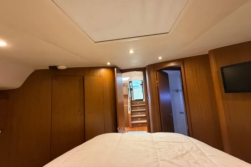  Yacht Photos Pics Interior of 2014 Tiara Yachts 4500 Sovran, featuring wood paneling and cozy lighting.