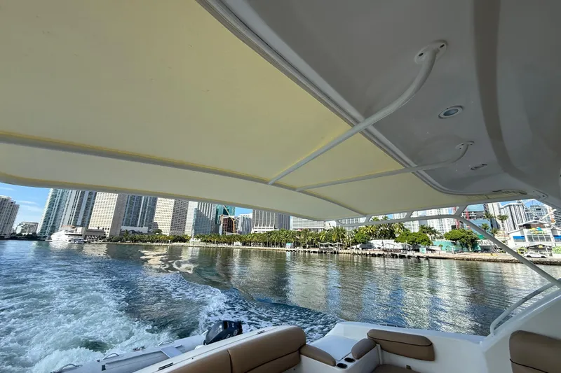  Yacht Photos Pics 2014 Tiara Yachts 4500 Sovran cruising near city skyline, view from deck.