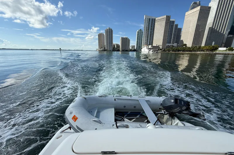  Yacht Photos Pics Tiara Yachts 4500 Sovran 2014 cruising near city skyline, leaving a wake.