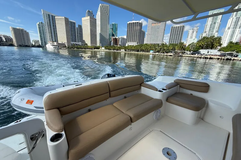  Yacht Photos Pics 2014 Tiara Yachts 4500 Sovran cruising with city skyline in the background.