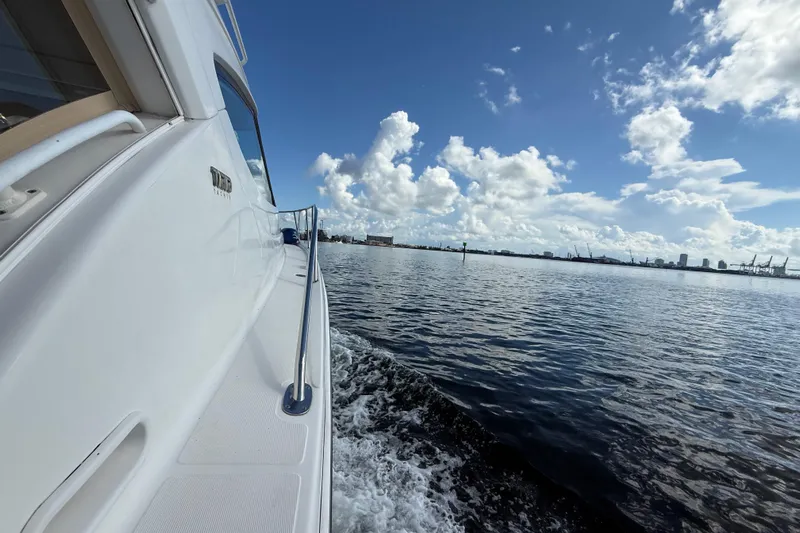  Yacht Photos Pics 2014 Tiara Yachts 4500 Sovran cruising on a sunny day with city skyline in view.