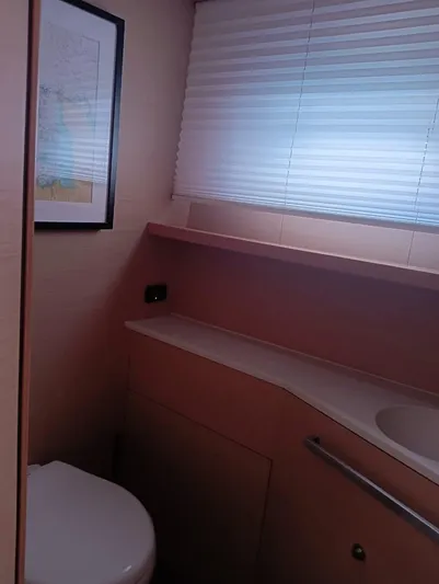 Finisterre Yacht Photos Pics Interior of 2017 Lagoon 52 F yacht bathroom with modern fixtures and window blinds.