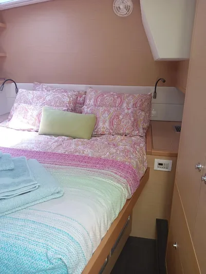 Finisterre Yacht Photos Pics Cozy bedroom in 2017 Lagoon 52 F yacht with colorful bedding and soft lighting.