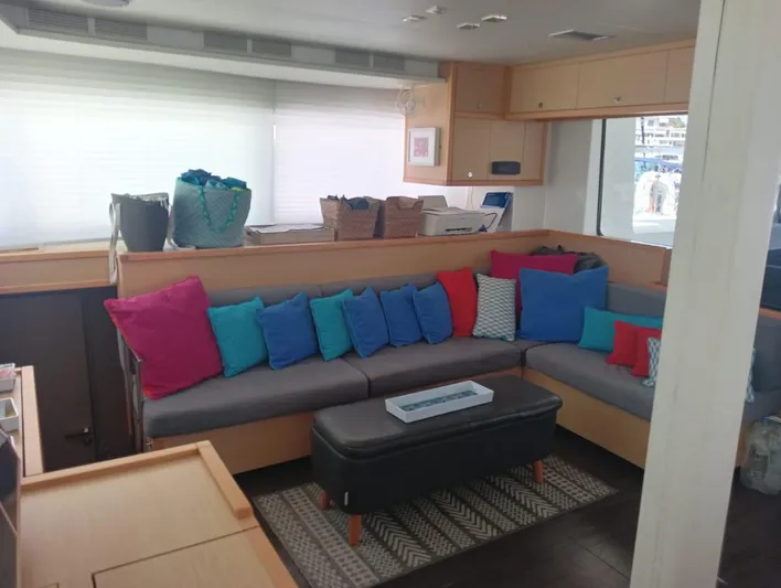 Finisterre Yacht Photos Pics Interior of 2017 Lagoon 52 F yacht with colorful cushions and modern decor.