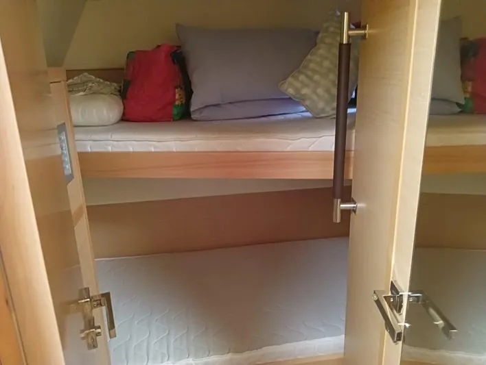 Finisterre Yacht Photos Pics Bunk beds inside a 2017 Lagoon 52 F yacht cabin with pillows and bedding.