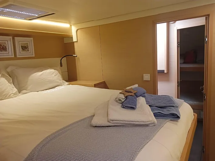 Finisterre Yacht Photos Pics Luxurious cabin interior of 2017 Lagoon 52 F yacht with cozy bedding and soft lighting.