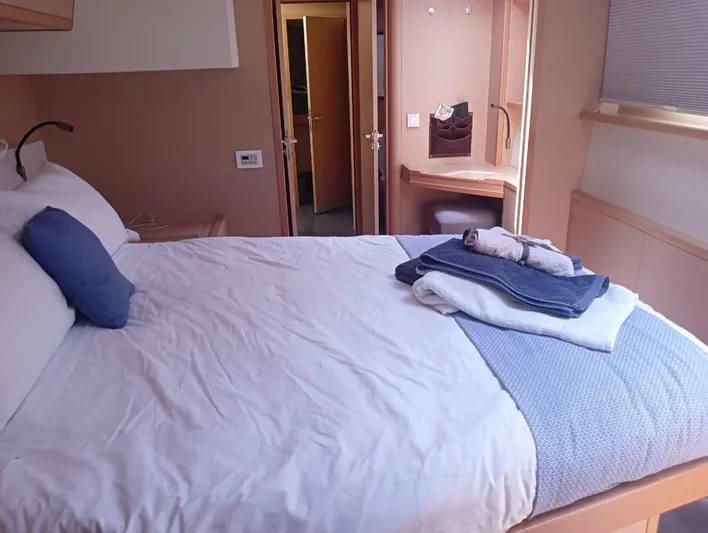 Finisterre Yacht Photos Pics Luxurious cabin interior of 2017 Lagoon 52 F yacht with neatly arranged bed linens.