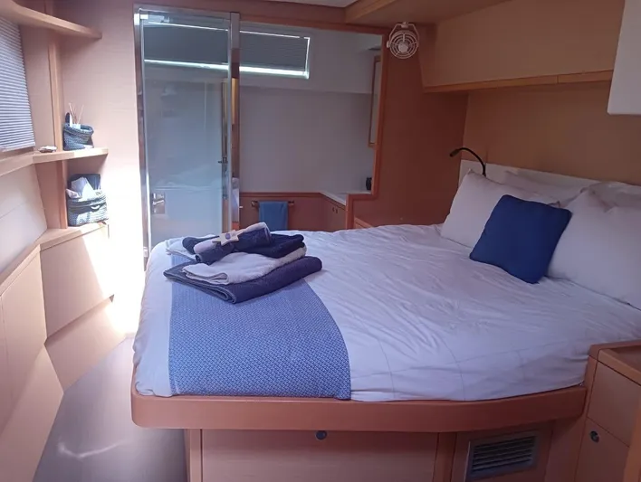 Finisterre Yacht Photos Pics Luxurious cabin interior of 2017 Lagoon 52 F yacht with cozy bed and modern decor.
