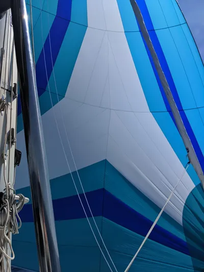 Finisterre Yacht Photos Pics Colorful sail of a 2017 Lagoon 52 F yacht, featuring blue and white patterns.