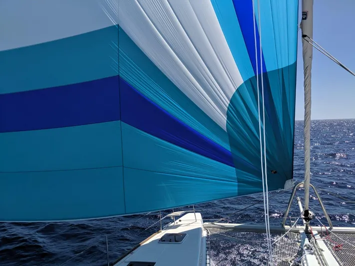 Finisterre Yacht Photos Pics Sailing on a 2017 Lagoon 52 F with vibrant blue sails over open ocean.