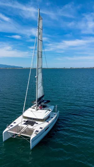 Finisterre Yacht Photos Pics 2017 Lagoon 52 F catamaran sailing on calm blue waters under a clear sky.