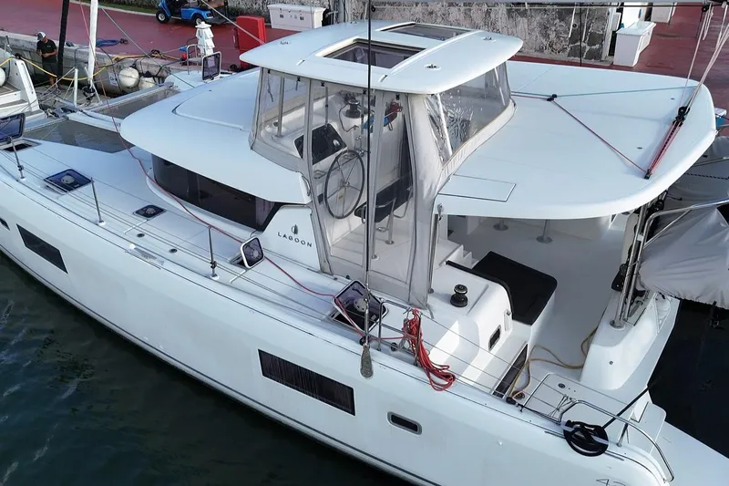  Yacht Photos Pics 2020 Lagoon 42 catamaran docked, featuring sleek design and spacious deck area.