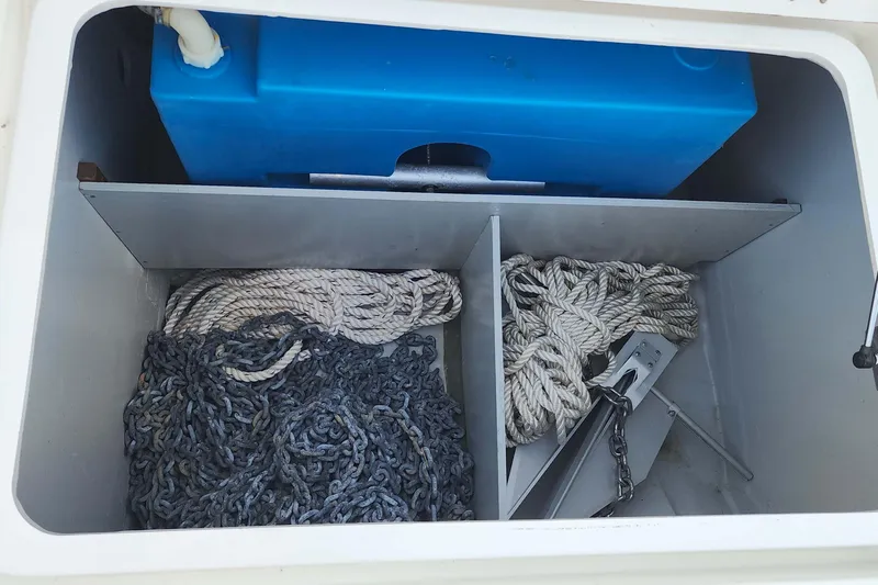  Yacht Photos Pics Storage compartment on a 2020 Lagoon 42 boat with ropes, chains, and a blue tank.