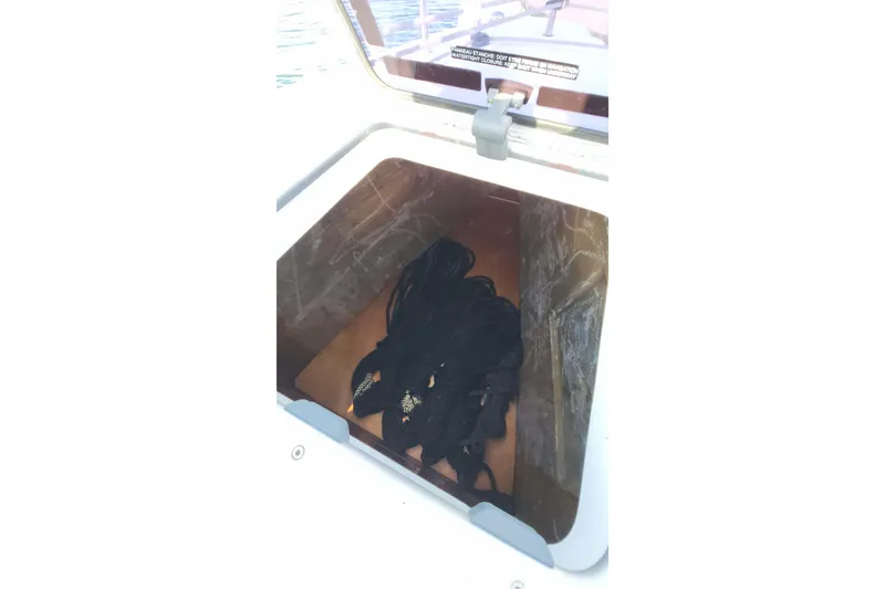  Yacht Photos Pics Storage compartment on a 2020 Lagoon 42 catamaran with coiled black ropes.