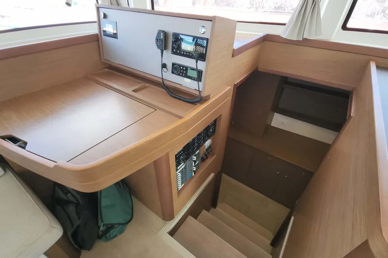 Yacht Photos Pics Interior of 2020 Lagoon 42 yacht with navigation station and wooden stairs.