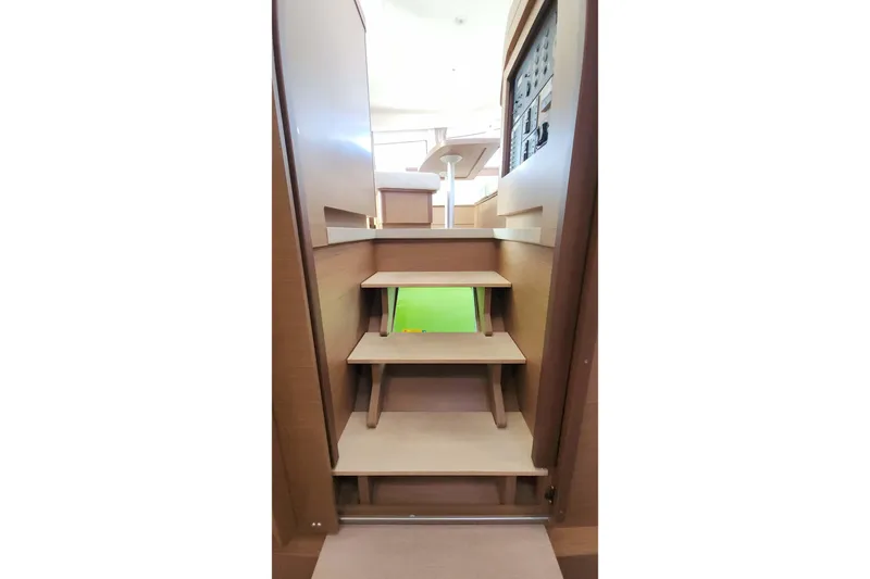  Yacht Photos Pics Interior stairs of 2020 Lagoon 42 catamaran, featuring wooden steps and modern design.