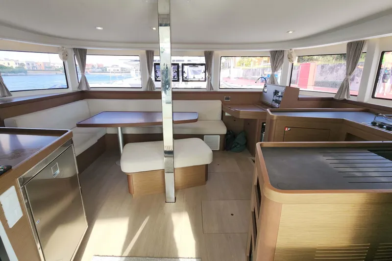  Yacht Photos Pics Modern interior of 2020 Lagoon 42 catamaran with spacious seating and panoramic windows.