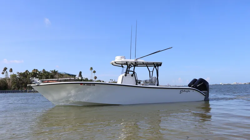  Yacht Photos Pics 2022 Yellowfin 32 Offshore boat on calm water, clear sky background.