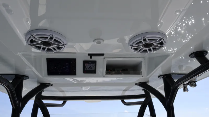  Yacht Photos Pics 2022 Yellowfin 32 Offshore boat interior with speakers and control panel.