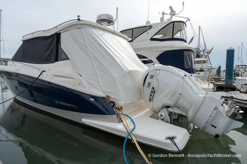 Qss Century Yacht Photos Pics 2024 Regal 36 XO yacht docked, featuring Yamaha outboard engine, covered in white tarp.