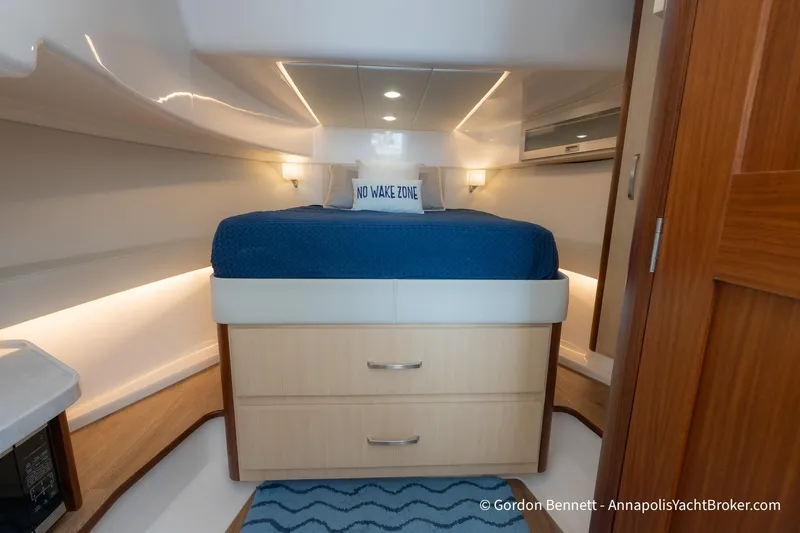 Qss Century Yacht Photos Pics Luxurious cabin interior of 2024 Regal 36 XO yacht with cozy bedding.