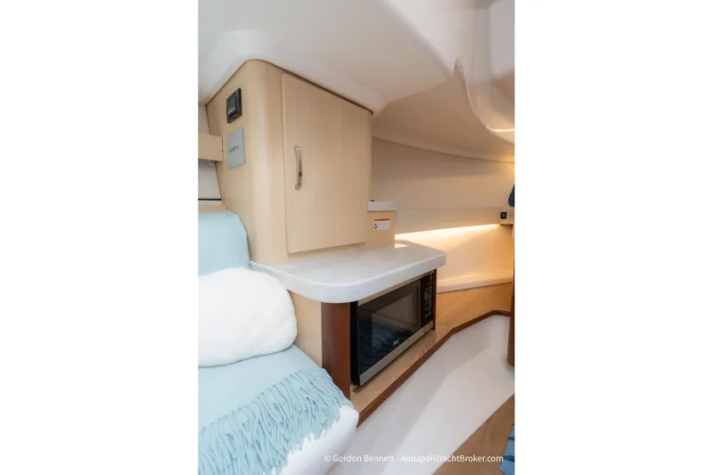 Qss Century Yacht Photos Pics 2024 Regal 36 XO yacht interior with microwave and wooden cabinetry.