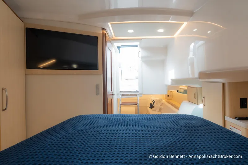 Qss Century Yacht Photos Pics Luxurious interior of 2024 Regal 36 XO yacht with modern amenities and cozy bedding.
