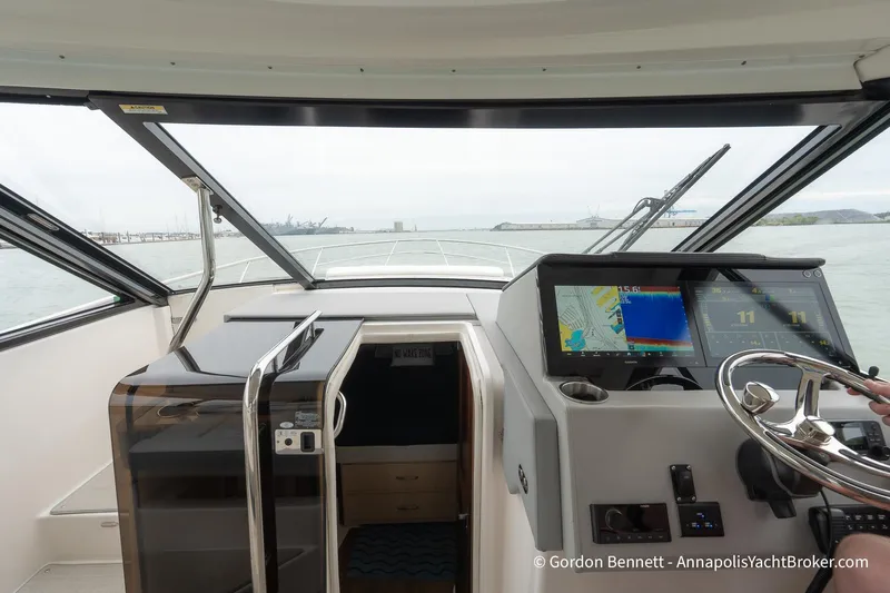 Qss Century Yacht Photos Pics 2024 Regal 36 XO yacht cockpit with navigation screens and steering wheel.