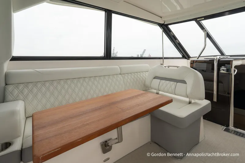 Qss Century Yacht Photos Pics Luxurious interior of 2024 Regal 36 XO yacht with elegant seating and wooden table.