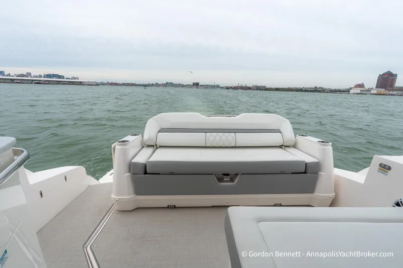 Qss Century Yacht Photos Pics 2024 Regal 36 XO yacht with luxurious seating, overlooking a scenic waterfront view.
