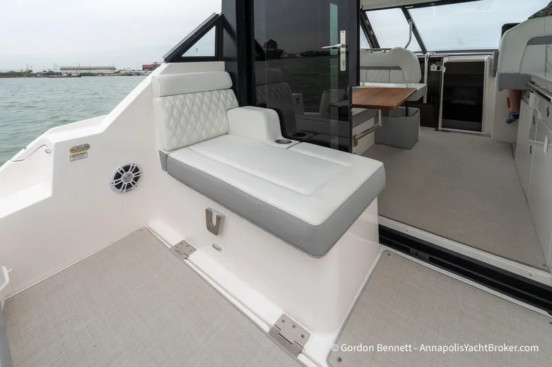 Qss Century Yacht Photos Pics 2024 Regal 36 XO yacht interior with seating and table, overlooking water.