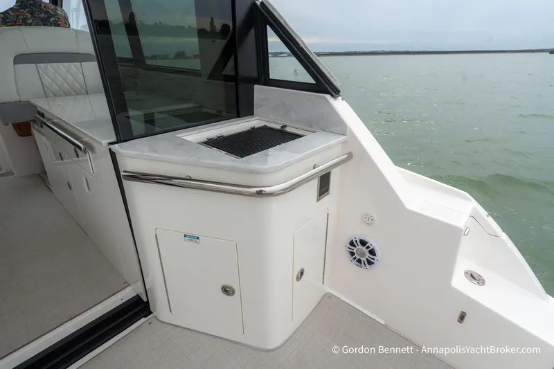 Qss Century Yacht Photos Pics 2024 Regal 36 XO yacht deck with outdoor kitchen and scenic water view.