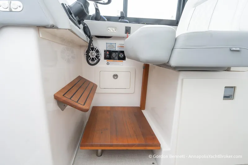 Qss Century Yacht Photos Pics 2024 Regal 36 XO yacht interior with wooden steps and control panel.