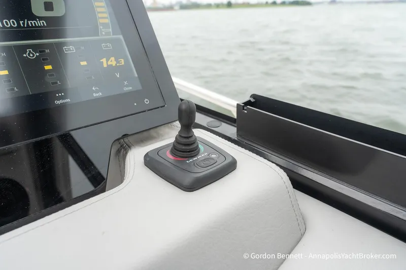 Qss Century Yacht Photos Pics Control panel and joystick on 2024 Regal 36 XO yacht, overlooking water.