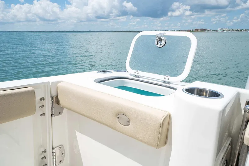  Yacht Photos Pics Manufacturer Provided Image: 2023 Pursuit DC 326 Dual Console boat with open storage compartment on calm water.