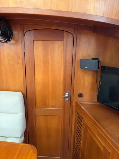 Diesel Duck Yacht Photos Pics Wooden interior of a 1999 Diesel Duck Trawler with door, seating, and electronics.