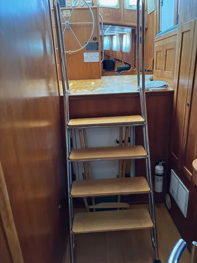 Diesel Duck Yacht Photos Pics Wooden stairs inside a 1999 Diesel Duck Trawler, leading to the upper deck.