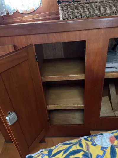 Diesel Duck Yacht Photos Pics Wooden cabinet with open door and shelves inside a 1999 Diesel Duck Trawler.