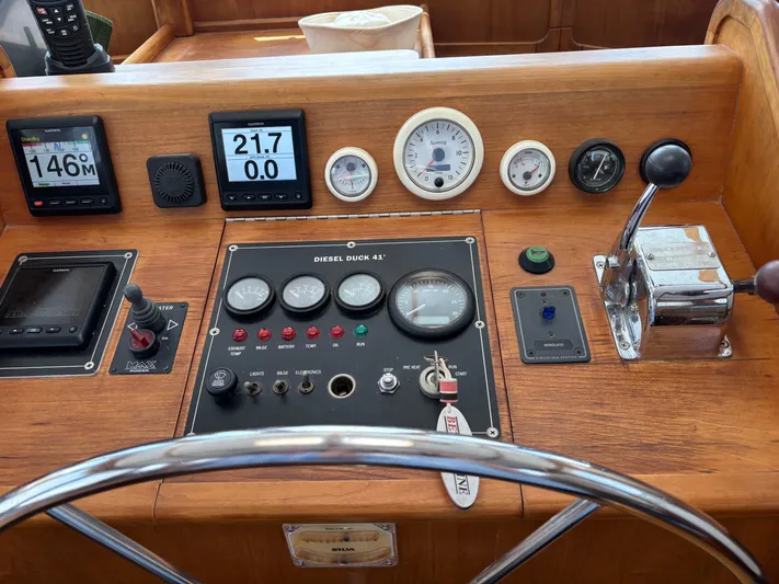 Diesel Duck Yacht Photos Pics 1999 Diesel Duck Trawler dashboard with gauges, controls, and steering wheel.