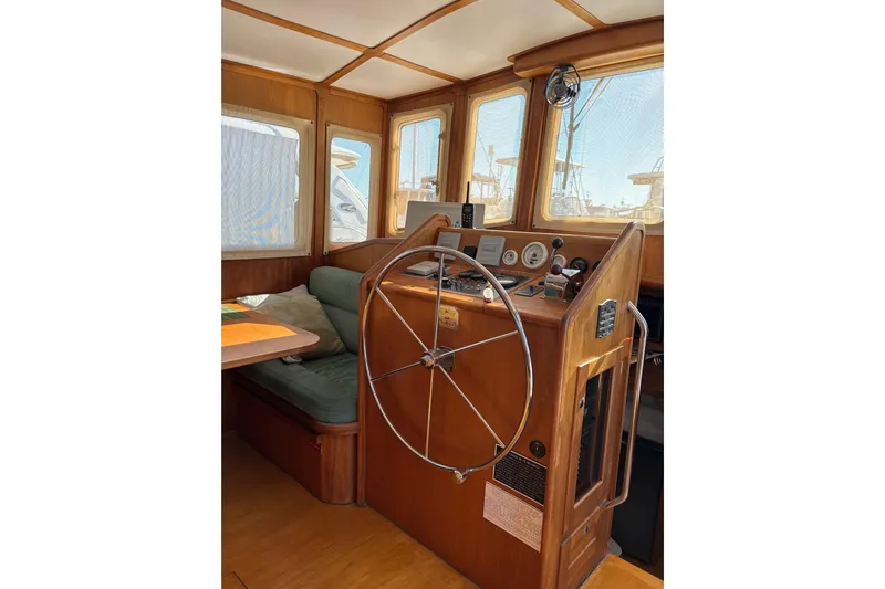 Diesel Duck Yacht Photos Pics 1999 Diesel Duck Trawler helm with wooden interior and navigation instruments.