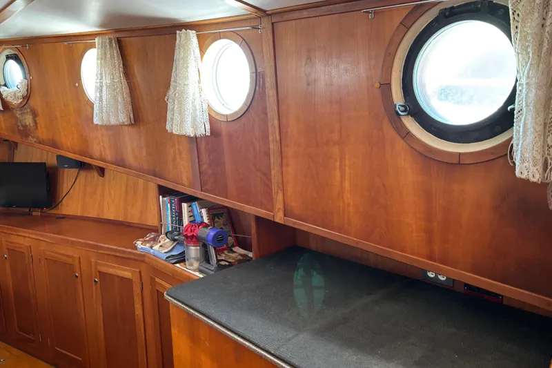 Diesel Duck Yacht Photos Pics Interior of 1999 Diesel Duck Trawler with wooden paneling and porthole windows.