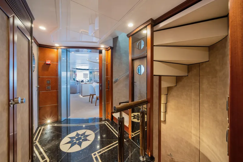 Titian Pearl Yacht Photos Pics Luxurious interior of 2001 CRN Magnifica 43 yacht with elegant staircase and polished flooring.