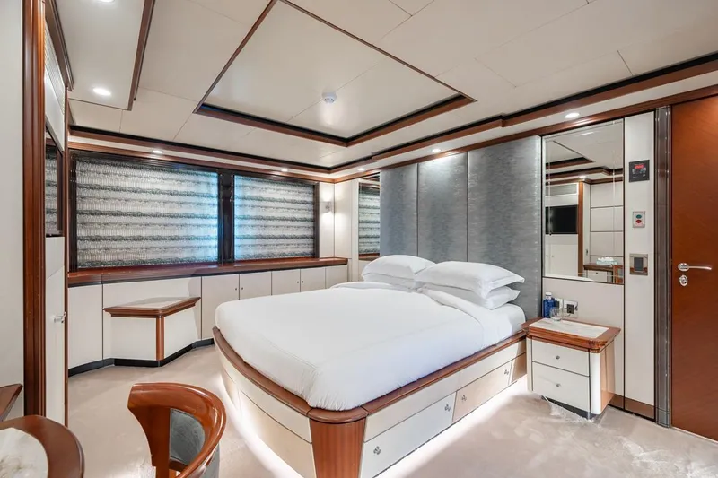 Titian Pearl Yacht Photos Pics Luxurious bedroom interior on 2001 CRN Magnifica 43 yacht, featuring elegant wood and modern design.