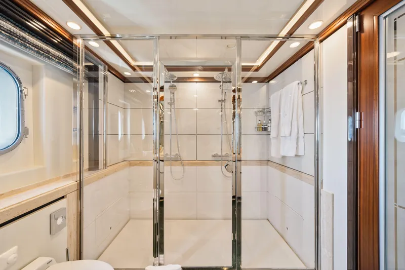 Titian Pearl Yacht Photos Pics Luxurious yacht bathroom with glass shower, elegant wood accents, and modern fixtures on CRN Magnifica 43.