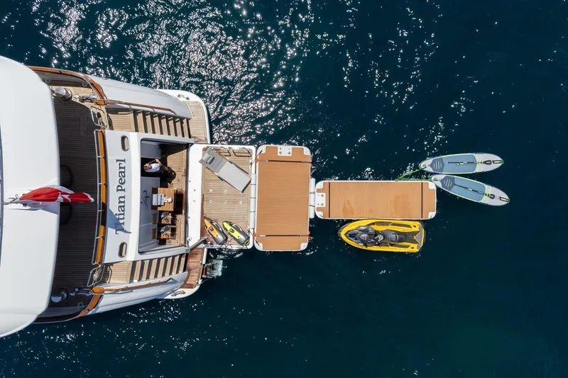 Titian Pearl Yacht Photos Pics Aerial view of CRN Magnifica 43 yacht with jet skis and paddleboards, 2001 model.