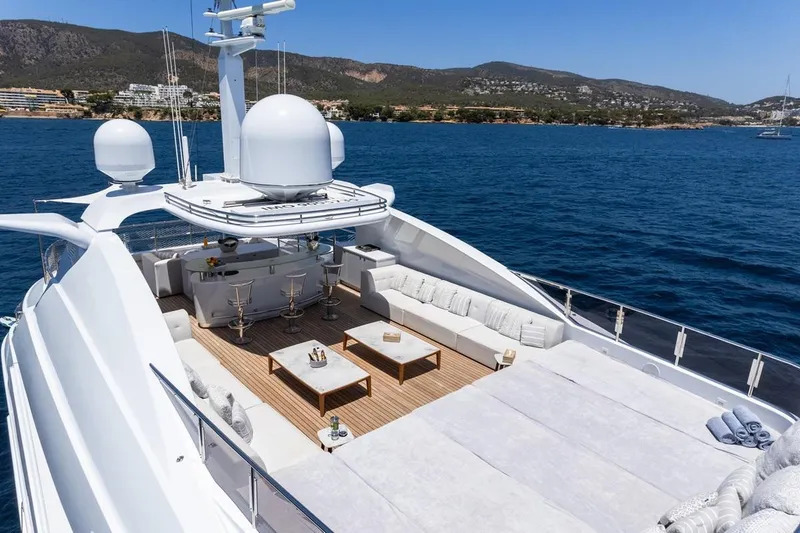 Titian Pearl Yacht Photos Pics Luxurious CRN Magnifica 43 yacht deck with seating, ocean view, and clear blue sky.