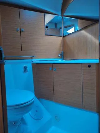 Miss Elli Yacht Photos Pics 2009 Jeanneau Sun Odyssey 44i yacht bathroom with wooden cabinets and modern fixtures.