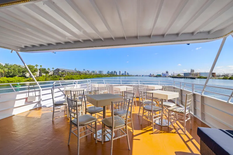  Yacht Photos Pics Outdoor deck of 1999 Skipperliner boat with tables, chairs, and scenic waterfront view.